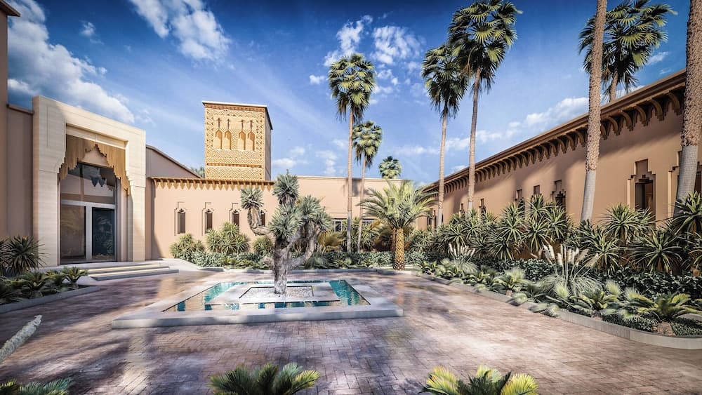 A serene courtyard featuring traditional Islamic architecture, lush palm trees, and a central water feature under a clear blue sky, ideal for cultural exploration and relaxation in a historic setting.