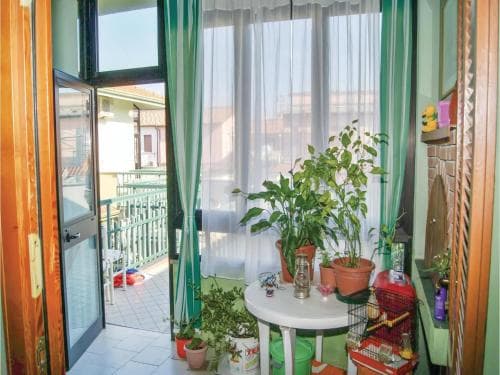 A cozy apartment balcony adorned with lush green plants and vibrant decor invites travelers seeking a tranquil retreat in an urban setting.