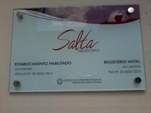 A close-up of an official registration plaque for "La Casona," a registered hotel in Salta, Argentina, displayed on a wall, ideal for travelers seeking certified accommodations.