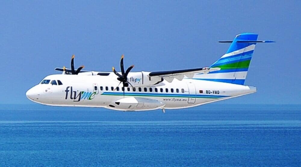 A Flyme ATR aircraft soars gracefully over the serene blue ocean, ideal for travelers seeking scenic flights to tropical destinations.