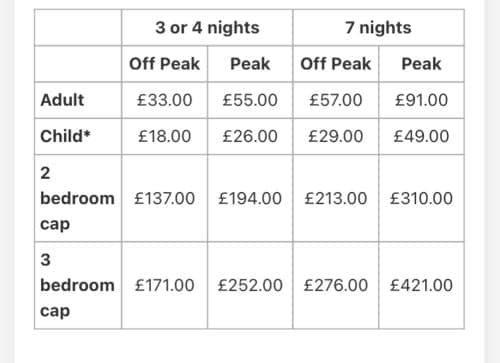 A detailed price table showcasing accommodation costs for adults and children in off-peak and peak seasons at a vacation rental property, ideal for travelers planning budget-friendly stays.