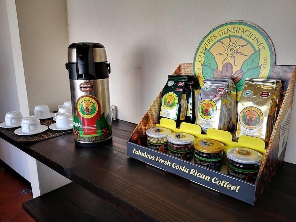 A cozy coffee corner featuring a French roast thermos and an inviting display of Costa Rican coffee beans and chocolates, perfect for travelers seeking authentic local flavors.