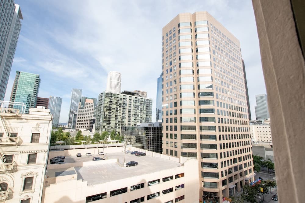 A vibrant urban skyline featuring modern skyscrapers and historic architecture under a clear blue sky, ideal for cityscape photography and business travelers exploring metropolitan areas.