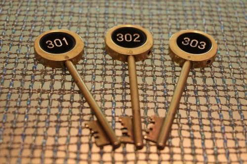 Three numbered vintage-style keys rest on a textured surface, evoking a nostalgic mood ideal for boutique hotel stays or heritage-themed accommodations.