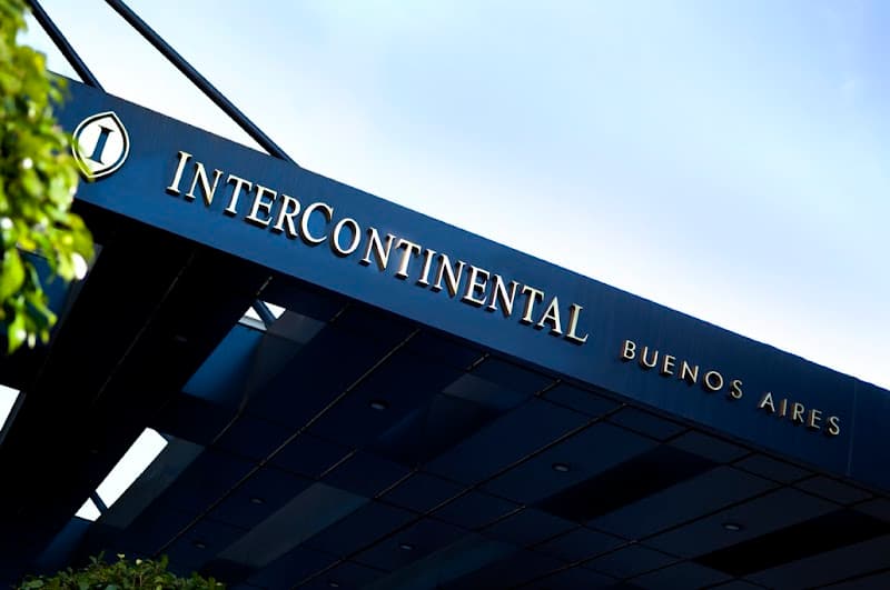 The sleek entrance of the InterContinental Buenos Aires hotel, marked by its prominent signage against a clear sky, exudes luxury and sophistication, ideal for travelers seeking upscale accommodations in the heart of the city.