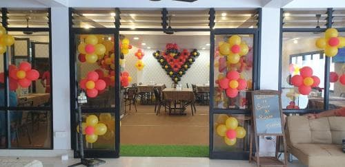 A vibrant indoor event space adorned with colorful balloon arrangements and festive decorations invites travelers seeking a cheerful venue for celebrations or gatherings.
