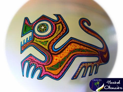 A vibrant, hand-painted ceramic piece featuring intricate patterns and a colorful animal motif, ideal for cultural souvenir shopping or art appreciation in a traditional craft market setting.
