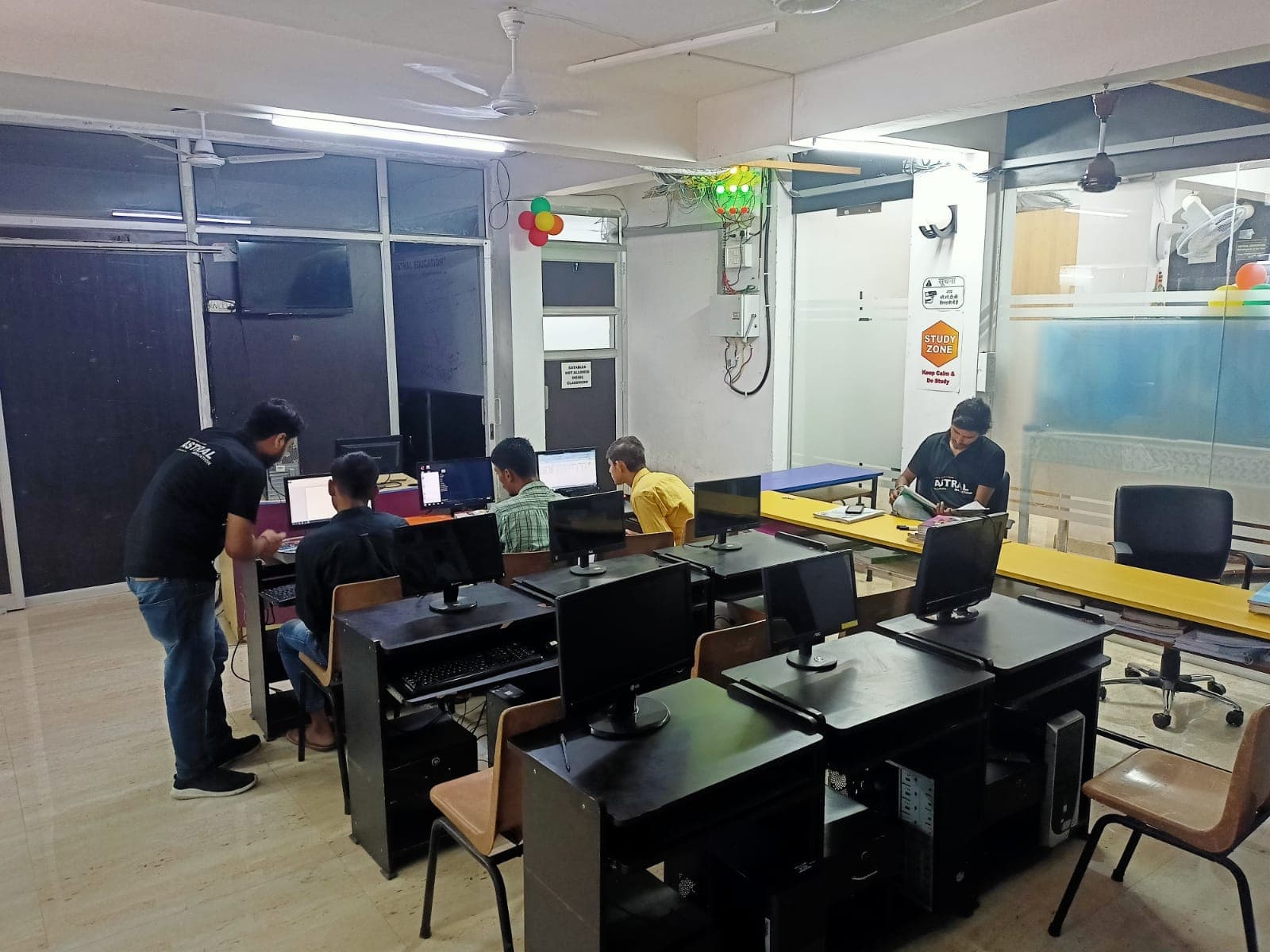 A focused learning environment in an education center features students working on computers at desks, with a "Study Zone" sign and colorful decorations enhancing the productive atmosphere, ideal for travelers seeking educational facilities in Gurugram, India.