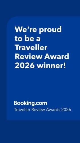 A vibrant blue graphic proudly announces a Traveller Review Award 2026 winner, ideal for travelers seeking top-rated accommodations as highlighted by Booking.com.