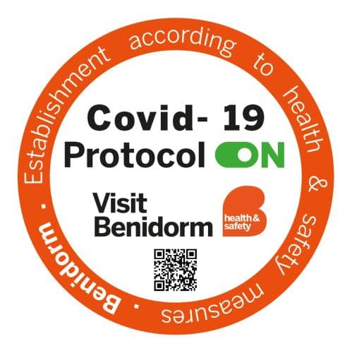 A vibrant orange circular badge promotes health and safety in Benidorm establishments with COVID-19 protocols active, featuring a QR code for travelers seeking secure tourism options.