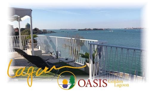 A serene balcony overlooks the expansive Golden Lagoon, featuring lounge chairs and lush greenery, ideal for travelers seeking relaxation in a tranquil waterfront retreat.
