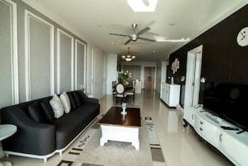 A modern living room with sleek furniture, a cozy sofa, and a minimalist design sets a tranquil mood, ideal for travelers seeking a stylish rental space for relaxation.