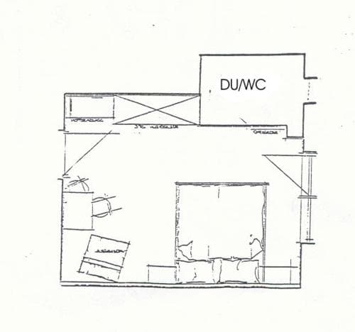A cozy apartment floor plan featuring a bedroom, living area, and DU/WC space, ideal for travelers seeking compact yet functional accommodations.
