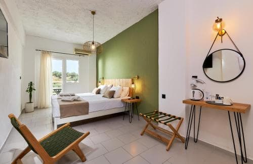A cozy hotel room with a vibrant green accent wall, modern furnishings, and a balcony view, exudes a relaxed and stylish atmosphere ideal for travelers seeking comfort and design in their accommodations.
