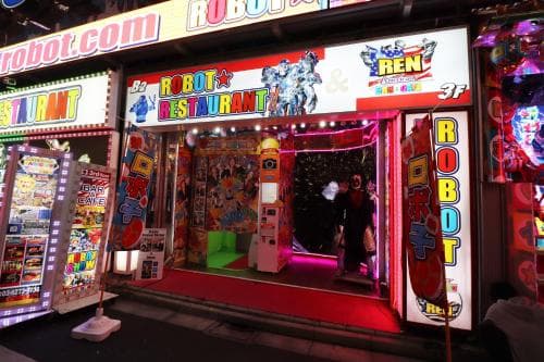A vibrant Robot Restaurant entrance in a bustling urban nightlife area, illuminated by colorful neon signs and featuring eye-catching robotic displays, creates an exciting and futuristic atmosphere perfect for unique dining experiences.