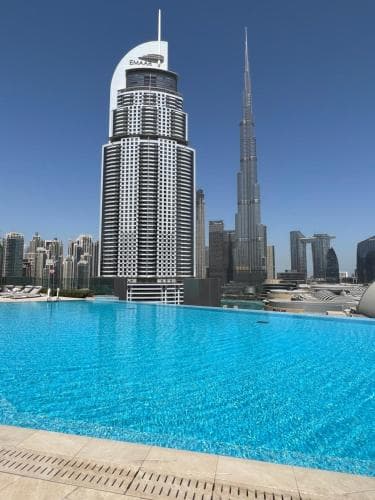 A serene rooftop pool overlooks the iconic Burj Khalifa in Dubai's futuristic skyline, perfect for luxury travelers seeking an exclusive urban retreat.