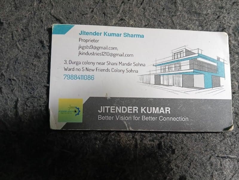 A business card for Jitender Kumar, proprietor of a property in Durga Colony, Sohna, Gurugram, lies on a textured surface, featuring contact details and a slogan promoting better vision for better connection, ideal for travelers seeking local business connections or accommodations.