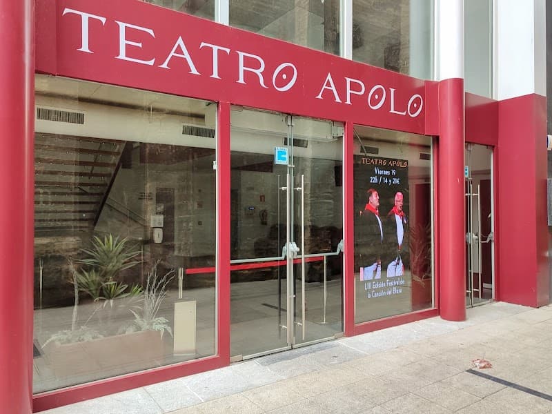 The vibrant red facade of Teatro Apolo in Miranda de Ebro, Spain, invites theater enthusiasts with its modern entrance and event posters, perfect for cultural exploration and entertainment.