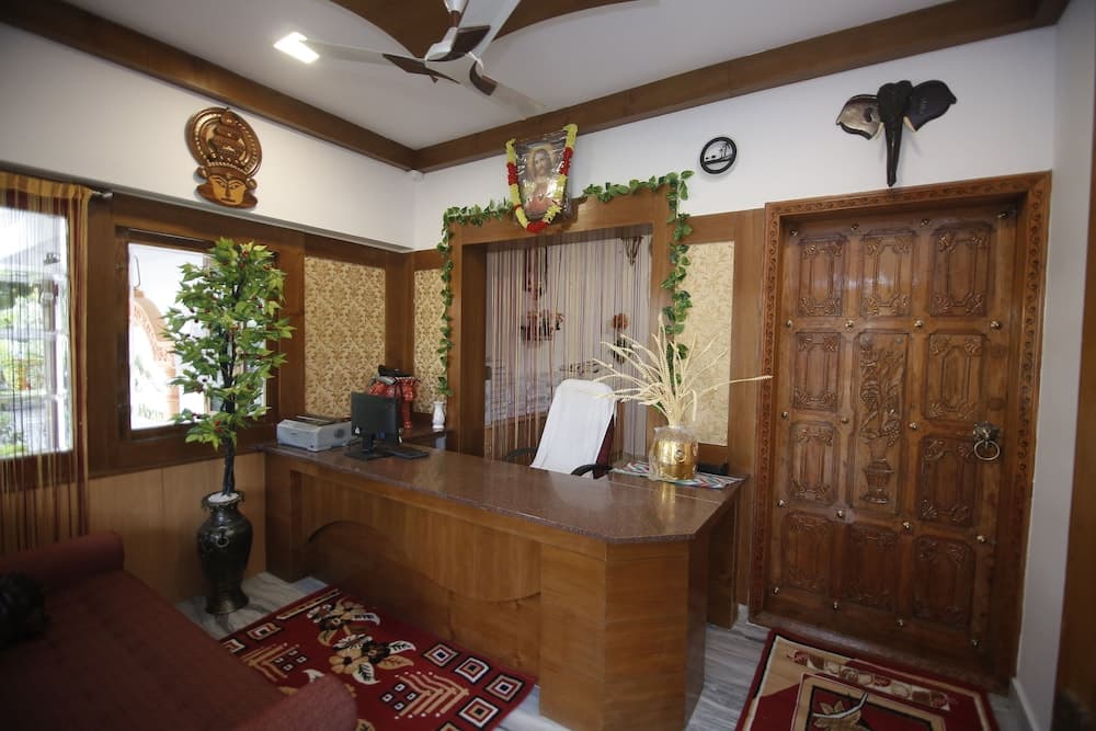 A cozy reception area with wooden decor, vibrant rugs, and cultural ornaments creates a welcoming atmosphere ideal for travelers seeking a traditional yet comfortable stay.