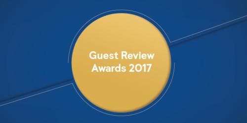 A vibrant graphic featuring a bold yellow circle on a deep blue background highlights the "Guest Review Awards 2017," ideal for event promotion or recognition in hospitality marketing materials.
