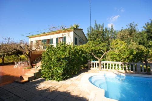 A serene Mediterranean villa with lush greenery, a tranquil pool, and a sunny patio invites travelers seeking a peaceful retreat for relaxation and rejuvenation.