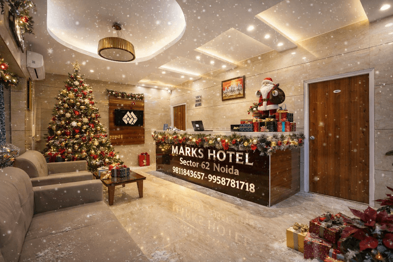 A festive hotel lobby adorned with a Christmas tree, twinkling lights, and holiday decorations creates a warm and inviting atmosphere at Marks Hotel in Sector 62, Noida, perfect for travelers seeking comfort during the holiday season.