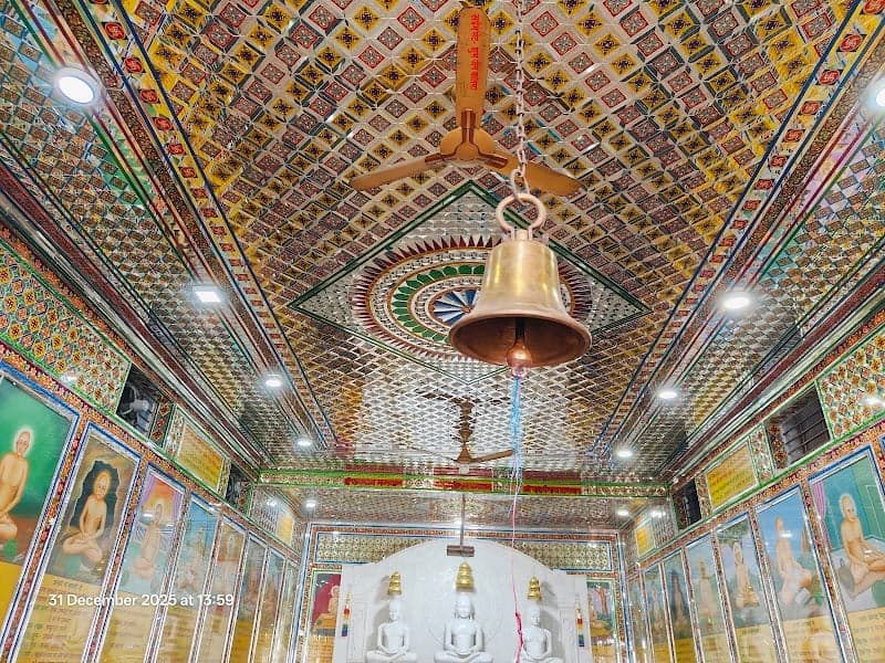 A vibrant and serene Jain temple interior in Jharkhand, India, features ornate tiled ceilings, golden statues, and colorful wall paintings, ideal for spiritual seekers exploring cultural heritage sites.