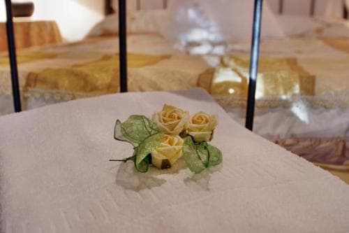 A serene wedding reception scene features delicate yellow roses on a white tablecloth, evoking elegance and romance, ideal for couples planning their special day.