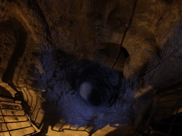 Derinkuyu Underground City tour inside a narrow rock-cut passage in Cappadocia