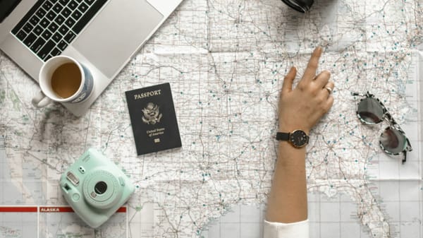 Wanderlog AI review planning workspace with a laptop and route map